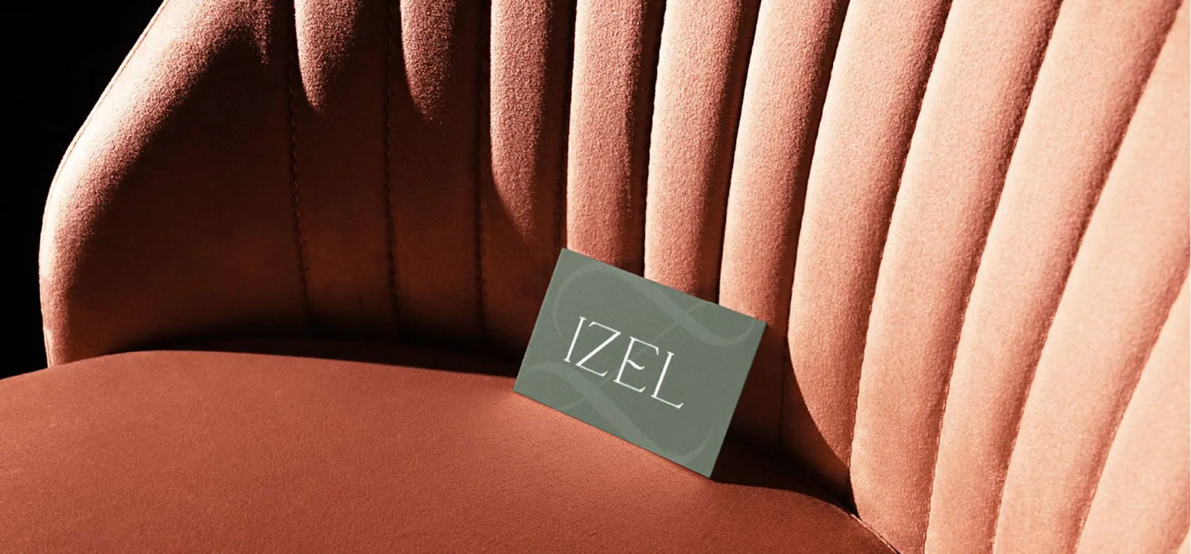 Izel business card resting on a velvet chair
